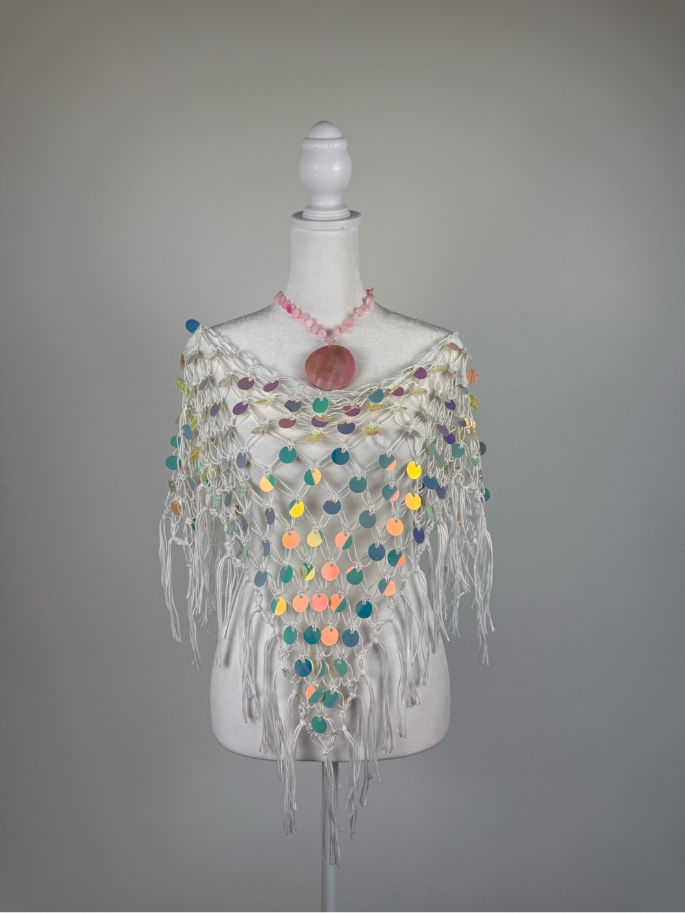 White crochet poncho with colorful sequin details and fringe 🤍✨